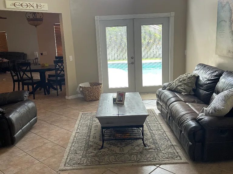 enter foyer to high ceiling living room with french doors that lead private pool and backyard area ample space for playground, garden or dogs