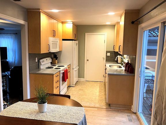 Galley kitchen. Sliding glass door gives access to backyard (on right).