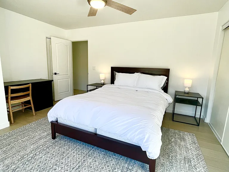 Bedroom number 3 features a queen bed, a built-in desk, closet, and a private door into the attached bathroom.