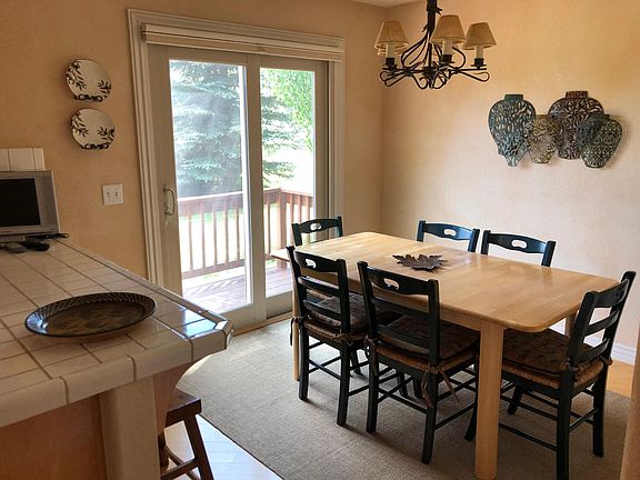 open kitchen, dining and den space all with mountain views