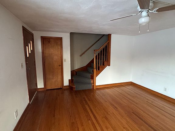 View of opposite side of living room and staircase to upstairs.