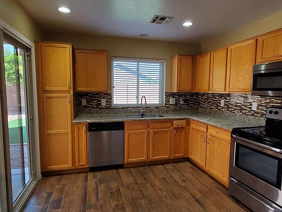 Stainless Steel Appliances, Tile back-splash, under cabinet lighting, usb outlet, Wood plank tiling, & sliding door with THREE locks