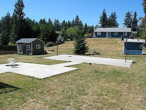 Backyard sports court, BBQ pit and shed