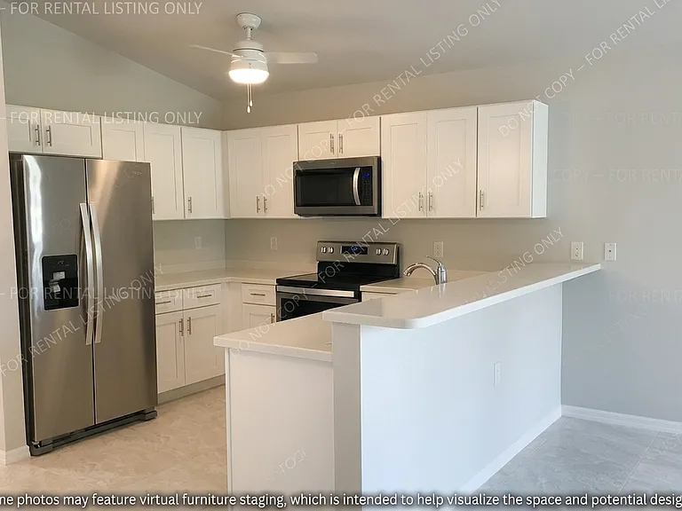 This bright and airy kitchen space boasts a clean, contemporary design complemented by an open layout that ensures you remain part of the conversation while preparing meals