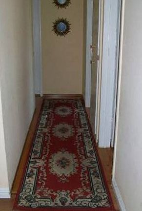 Hallway leads to 3 rooms
