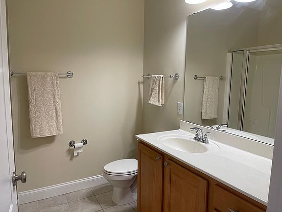 Large tiled master bathroom with linen closet