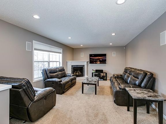 Looking in the opposite direction, the living room has a gas fireplace and built in speakers. Large window overlooking the backyard makes this room light and bright.