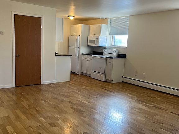 Living space next to kitchen with coat closet