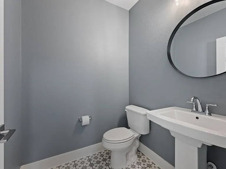 Functional and elegant powder bathroom off main living area.