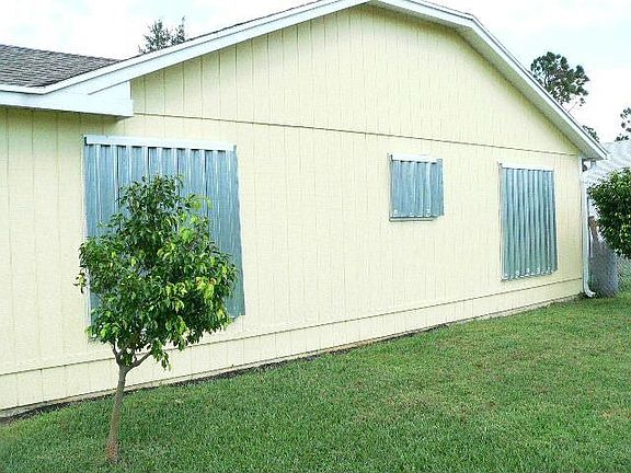 Back of house with hurricane shutters