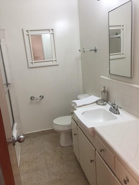 Newly reglazed tub and shower combo. New carrera marble look floor