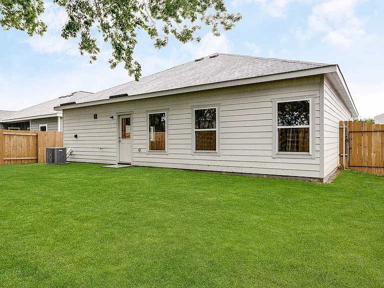 The back yard is fully fenced-in.