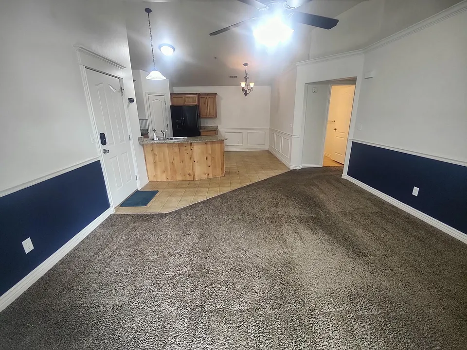 Spacious front room, vaulted ceilings, and kitchen.