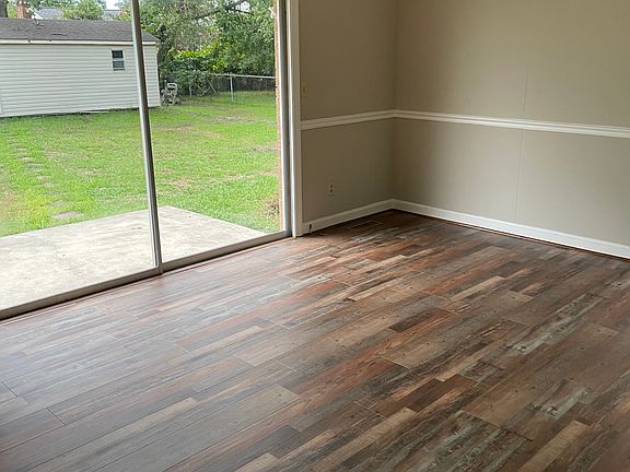 Den showing storage building in the back yard