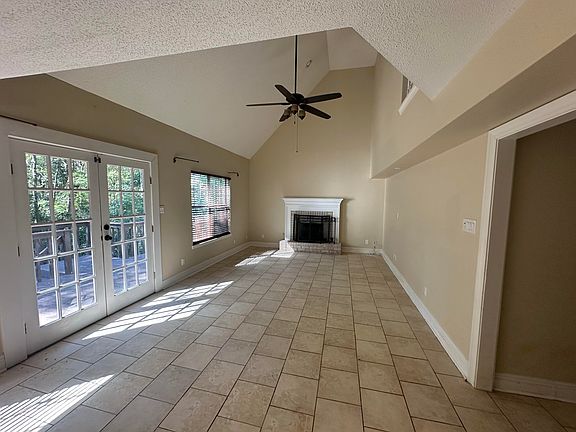 Large living room with lots of natural light, soaring vaulted ceilings and easy access to kitchen & breakfast area!