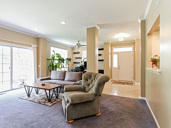 Living Room with recessed lighting, patio doors lead out the the cement patio.  Great natural sunlight.  Patio Doors were replaced in 2017!