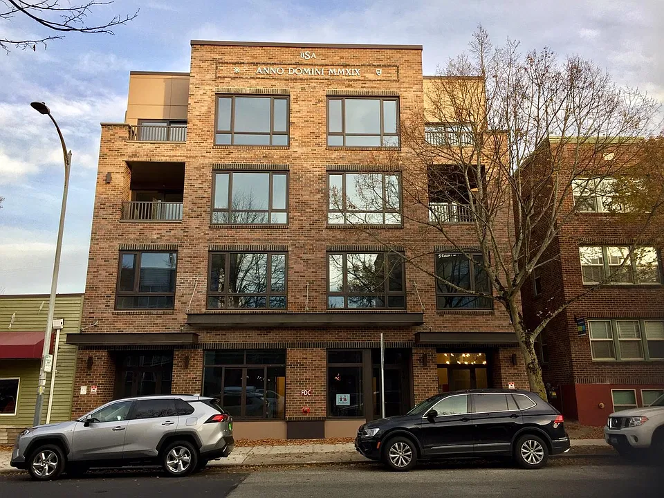 Front of building, classic brick facade, balconies facing California Ave SW