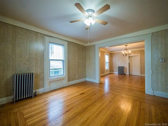 Living room with window trim and hardwood floors