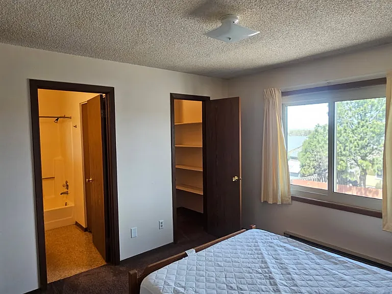 View of walk in closet and bathroom