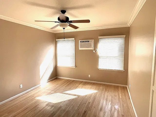 Bedroom with Wall A/C and Ceiling Fan