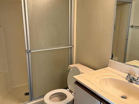 Downstairs bathroom with shower and sink.