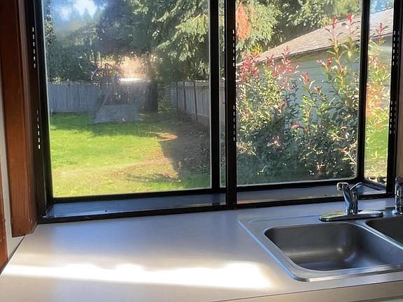 Garden window in kitchen looking out towards large back yard.