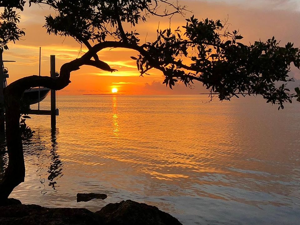Sunset view from the mini beach directly next to the house in our homeowners park. All of the views of being on the water for half the price.