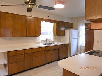 Kitchen offers refrigerator, electric range & ceiling fan