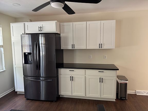 View of kitchen with pantry and cabinet storage.