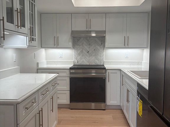 Fully equipped kitchen with brand-new, never-used appliances _ dishwasher, oven, fridge all included.