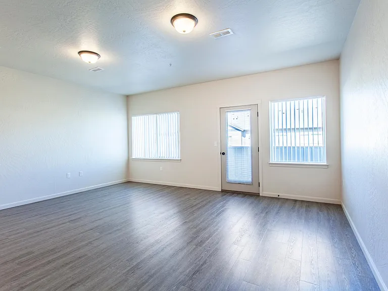 One bedroom living room with ample lighting and all homes come with 9' ceilings