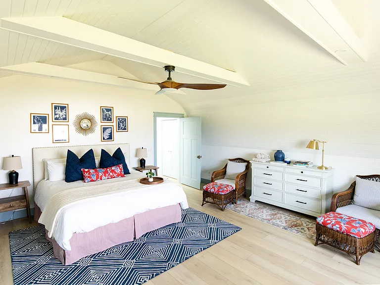 The master room includes a king size bed, built-in closet space, a dresser, a desk, and a smart TV