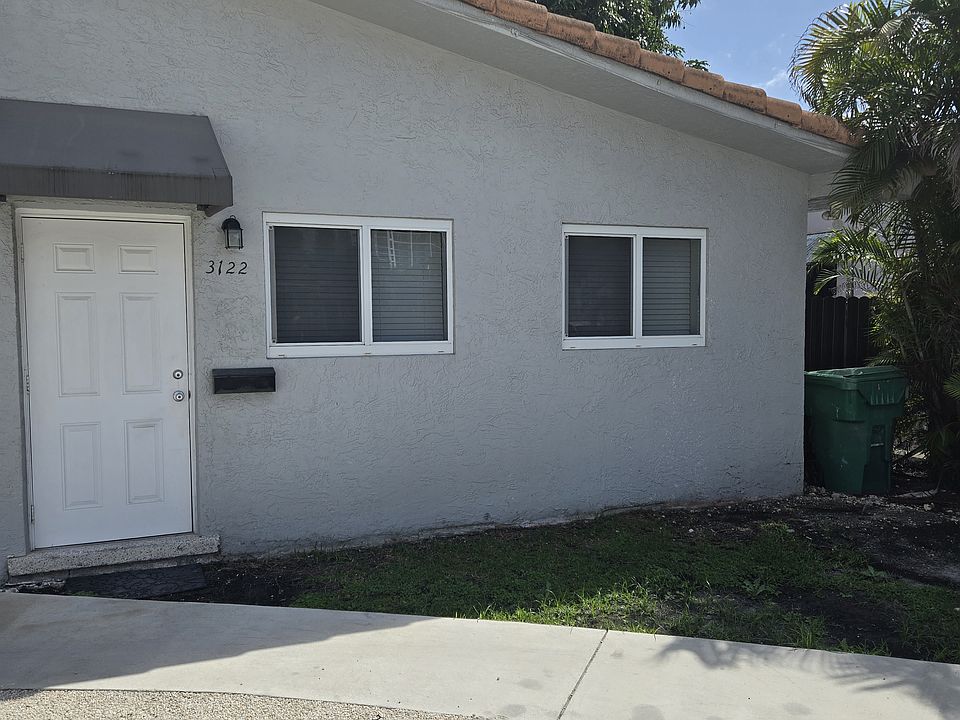 Outside front view of apartment with parking space on property.