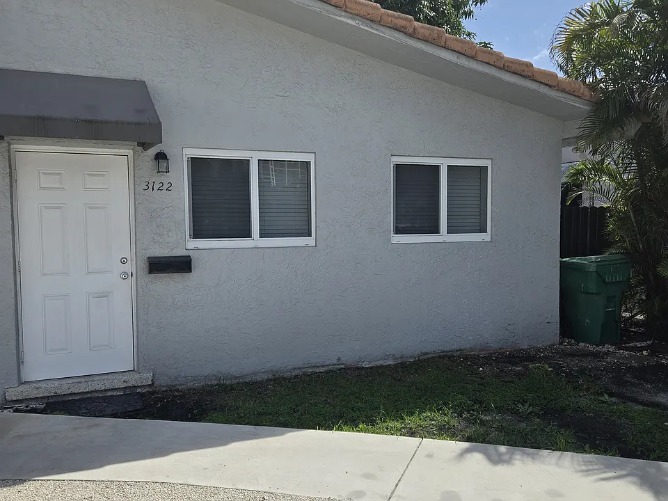 Outside front view of apartment with parking space on property.
