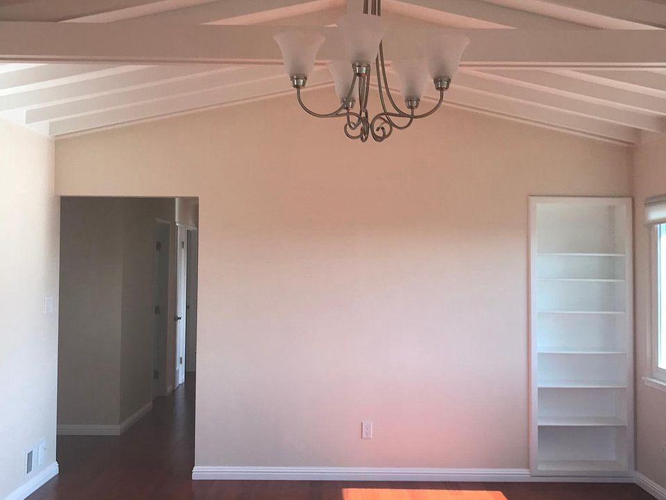 LR has Chandelier & Built In Shelving