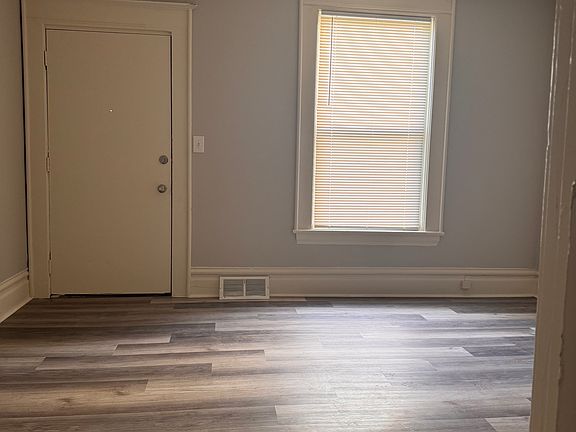 Living room looking from bathroom. 2nd exit door in living room