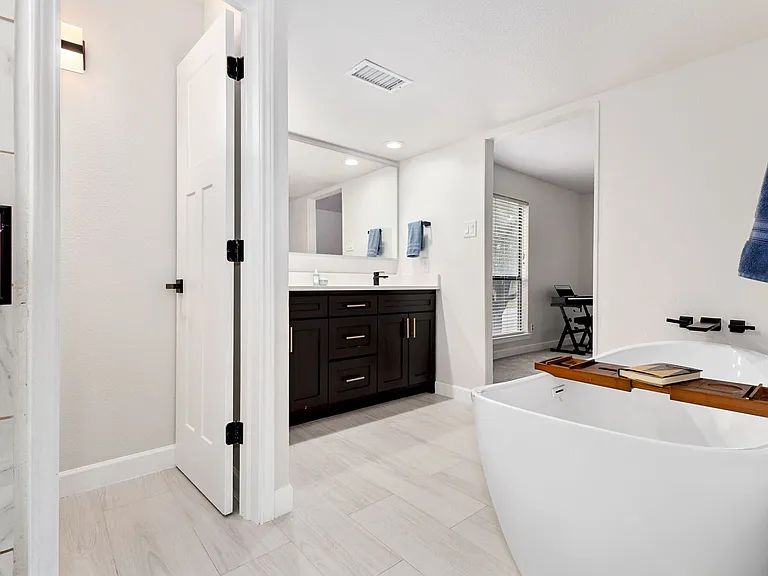 Bathroom featuring vanity and a tub