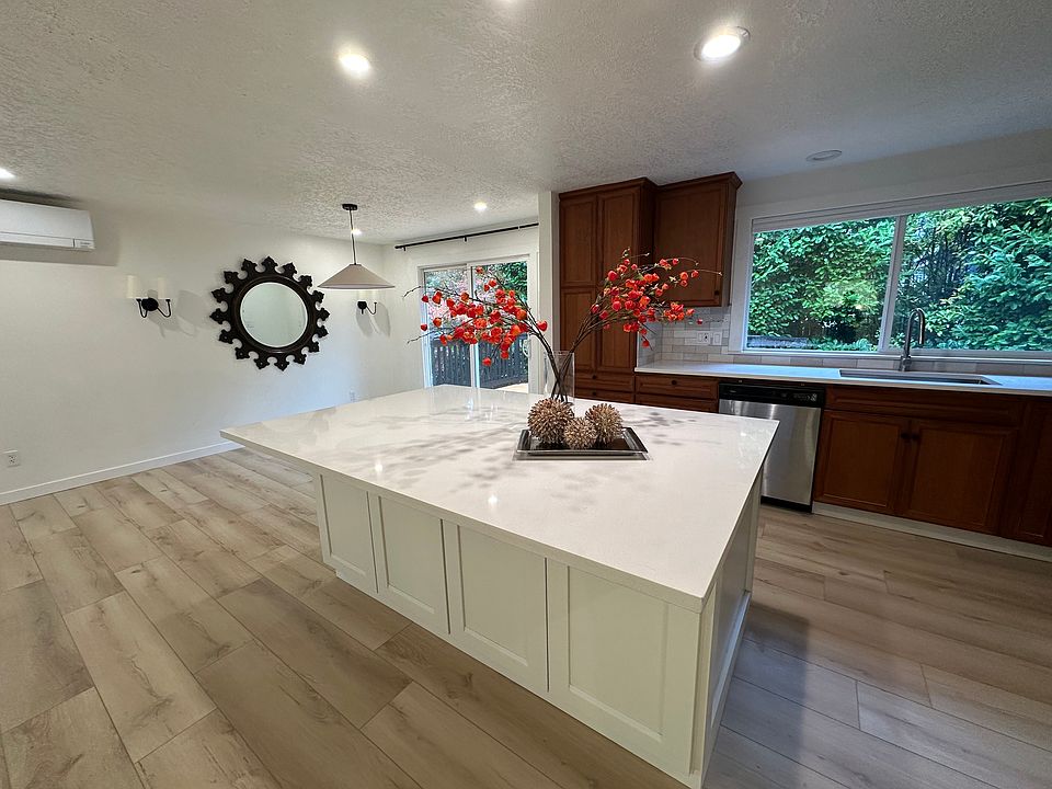 open-concept kitchen, dining, and living spaces