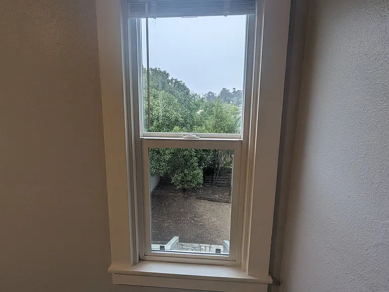 Bedroom far back window looking into backyard.