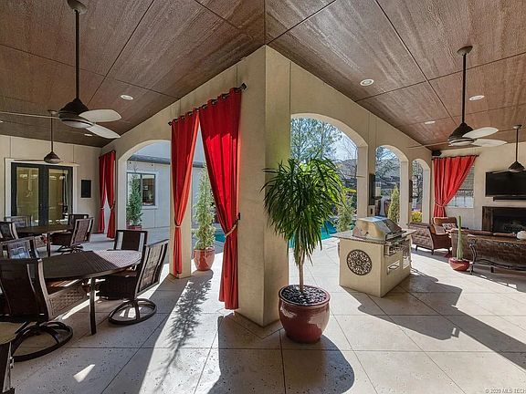 Pool with covered patios, hot tub, dining area, drink cooler, sink and grill