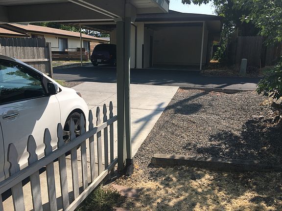 Back paved carport of duplex