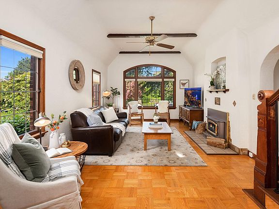Main floor living room; TV in corner and fireplace on south wall.