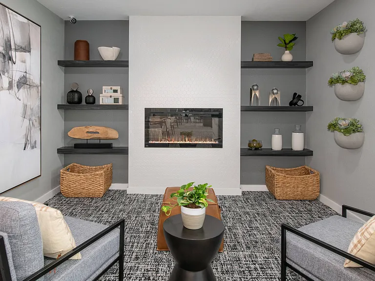 Relax in our inviting community lounge featuring comfortable seating and a cozy fireplace, professionally operated by Highlands Vista Group.