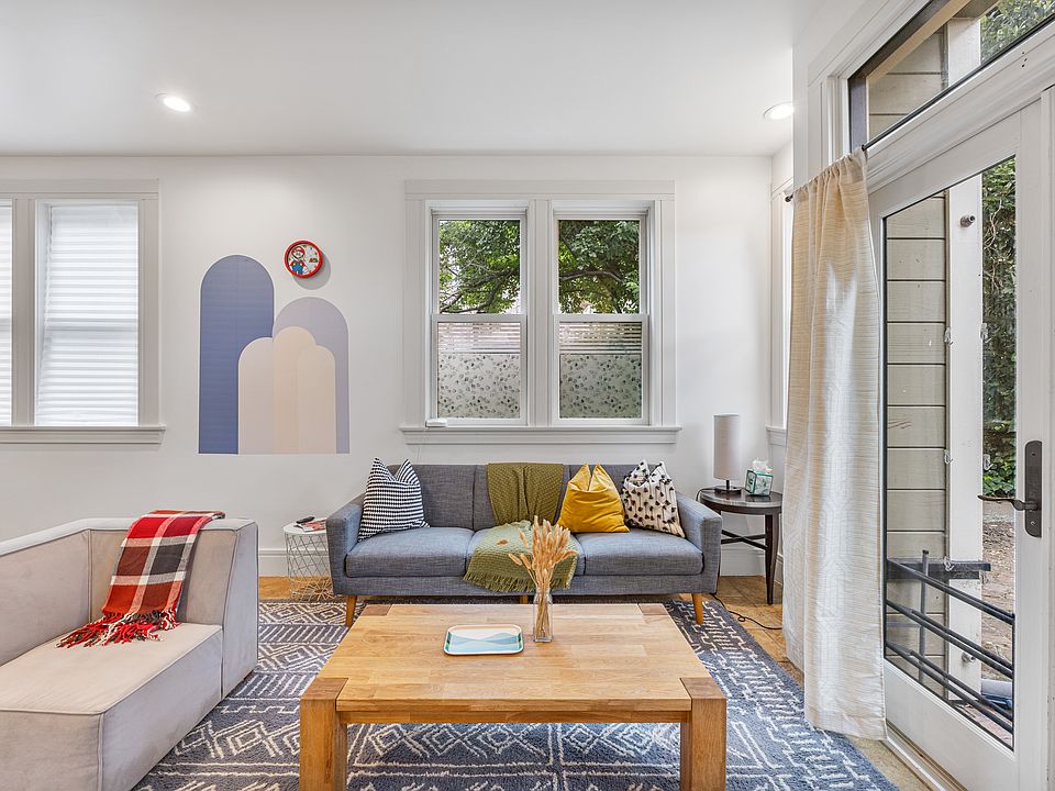 Spacious living room with smart TV and direct access to an outdoor patio.