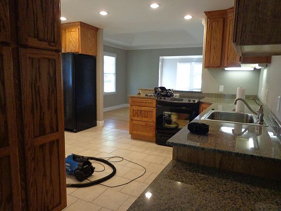 View looking from bedroom door through kitchen, dining, and living room