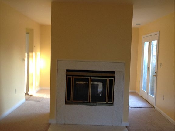 Living room/dining room separated by double sided fireplace