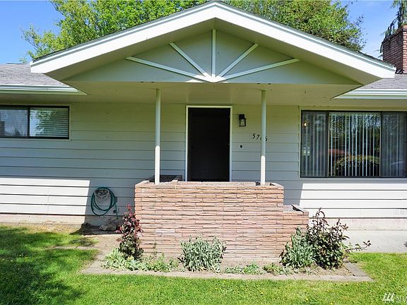 Covered entry & brick planting box.