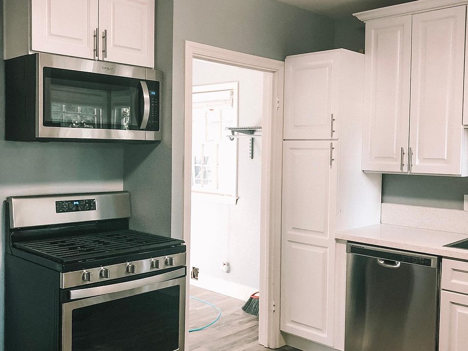 Stainless appliances. Doorway leads to your personal laundry