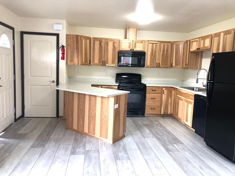 Entry door to the left, closet door and kitchen
