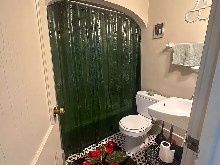 Fully tiled bathroom with huge linen closet behind the door